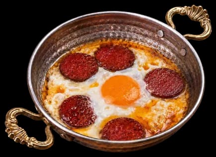 Menemen with butter served in a copper pan