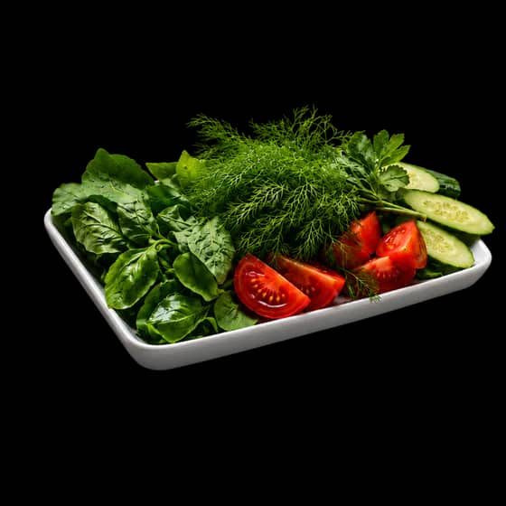 Plate of fresh herbs and vegetables